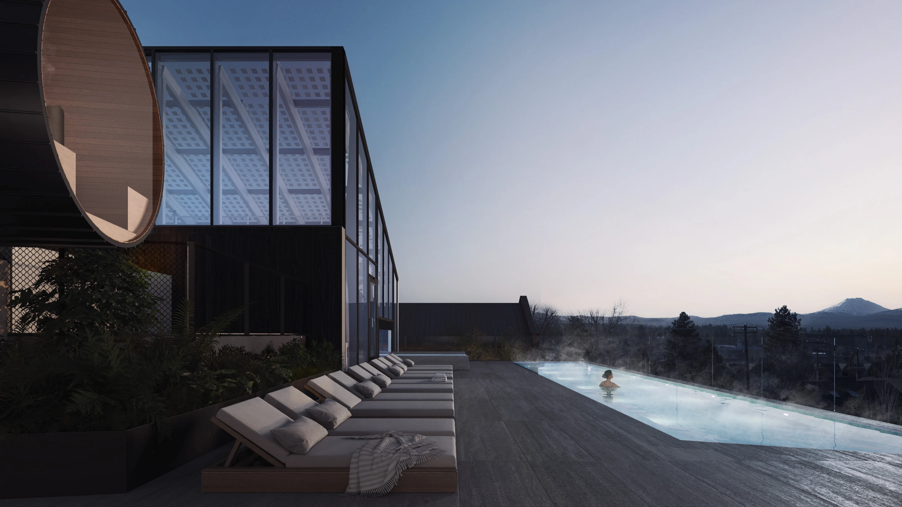 CASCADA Bend rooftop pool at dusk, with the Cascade mountains beyond