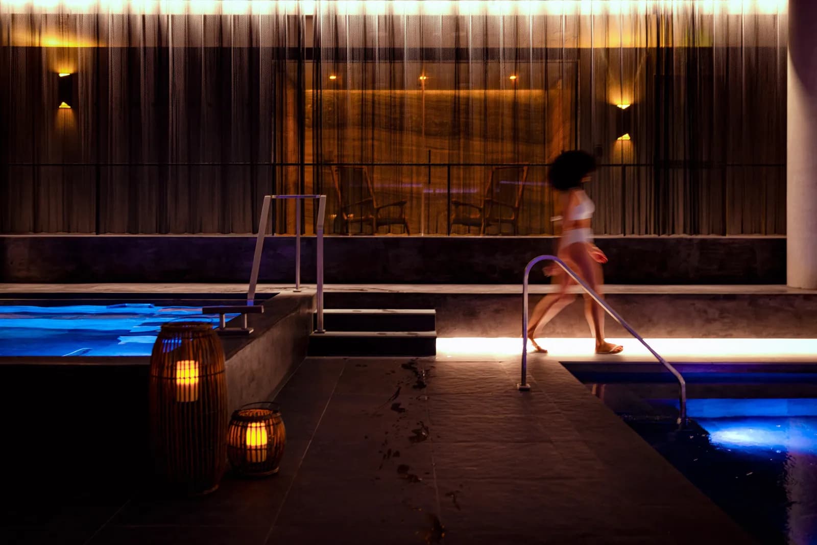 Warm lighting and blue water in the Thermal Springs sanctuary